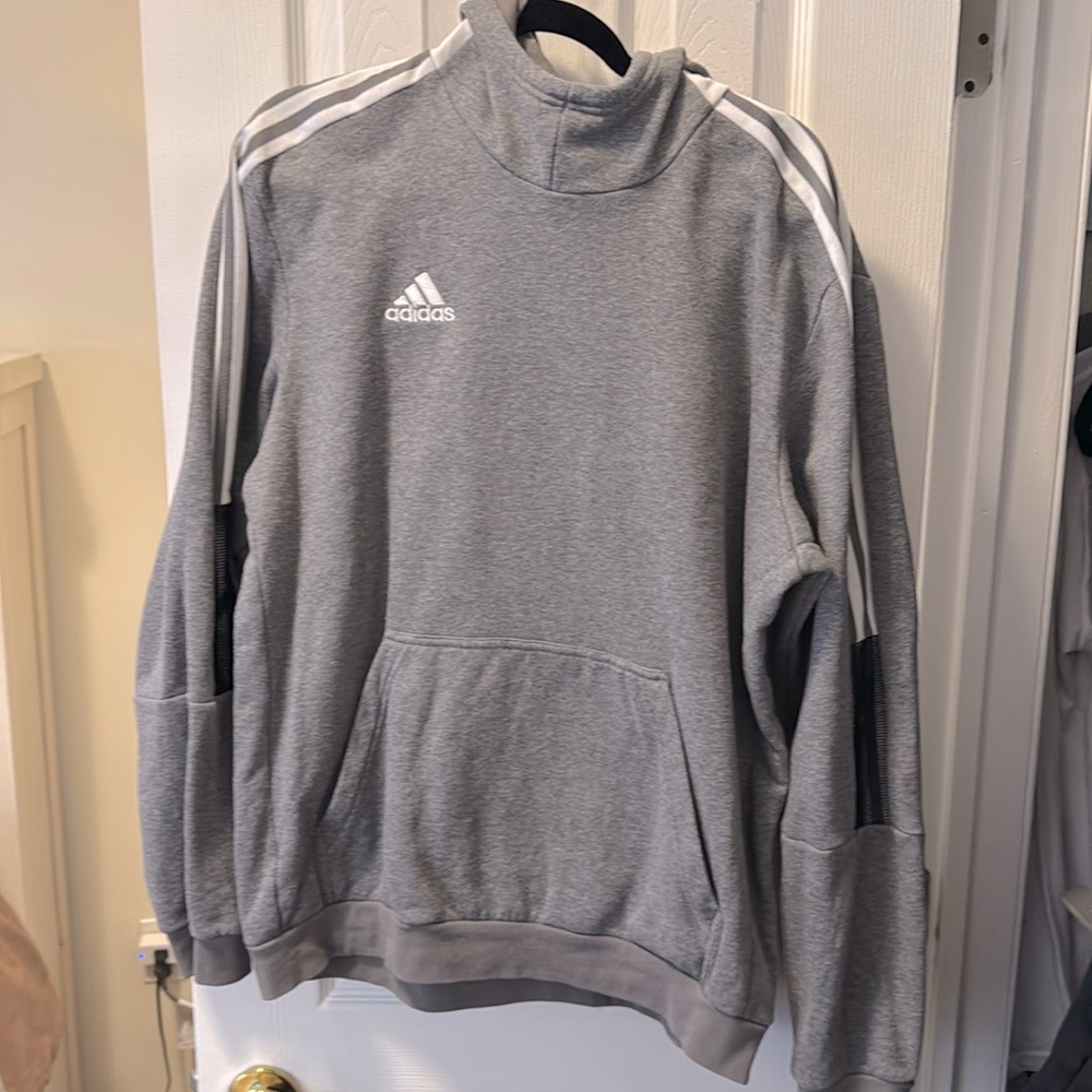 Gray Adidas sweatshirt with black semi-mesh arms, white stripes